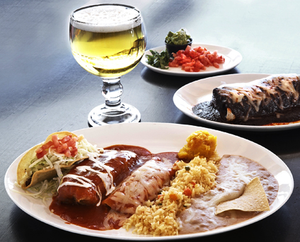 enchilada with beer and sides