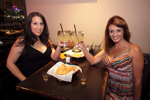 two ladies toasting with drinks